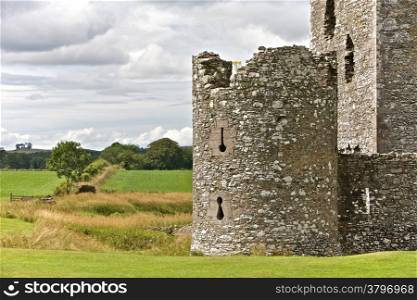 Castle Ruins Standing in Green Grasslands. Threave Castle ruins surrounded by pastures in Scotland