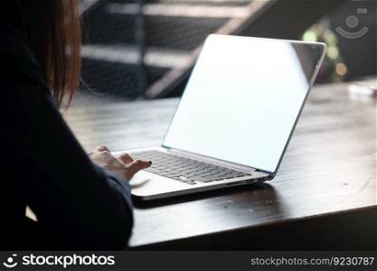 Casual business woman works online on laptop which hand on keyboard in her house Isolated screen in laptop (blank white screen)