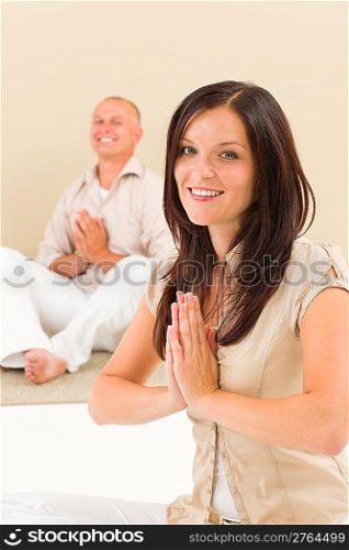 Casual business yoga young woman meditating with senior businessman colleague