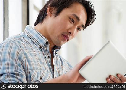 Casual businessman using digital tablet