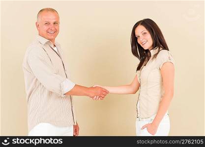 Casual businesswoman attractive smiling handshake with businessman colleague
