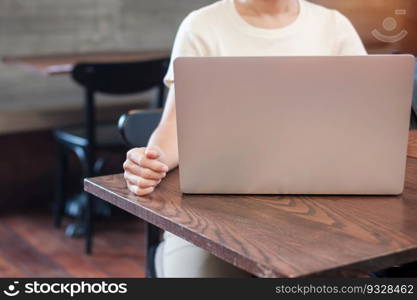 Casual Businesswoman using laptop, freelance woman typing keyboard computer notebook in cafe or modern office. technology, digital online and network concept