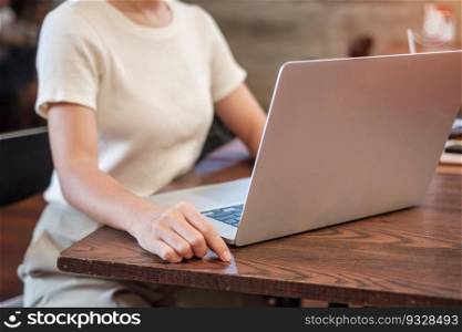 Casual Businesswoman using laptop, freelance woman typing keyboard computer notebook in cafe or modern office. technology, digital online and network concept