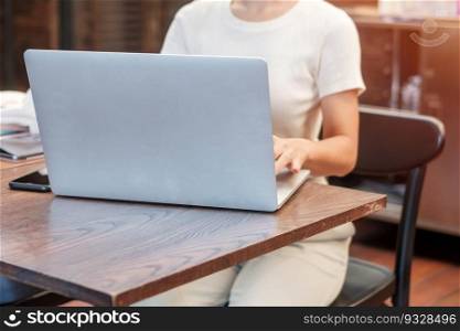 Casual Businesswoman using laptop, freelance woman typing keyboard computer notebook in cafe or modern office. technology, digital online and network concept