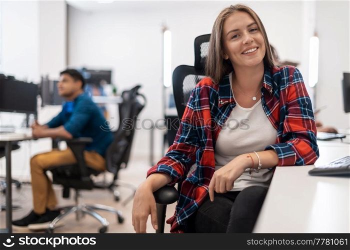 Casual businesswoman working on a desktop computer in modern open plan startup office interior. Selective focus. High-quality photo. Casual business woman working on desktop computer in modern open plan startup office interior. Selective focus