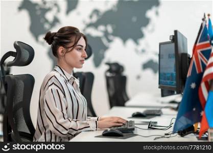 Casual businesswoman working on a desktop computer in modern open plan startup office interior. Selective focus. High-quality photo. Casual business woman working on desktop computer in modern open plan startup office interior. Selective focus 