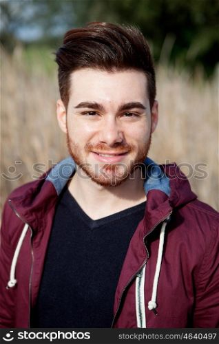 Casual cool young man with beard in the field