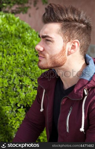 Casual cool young man with beard in the street