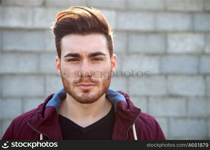 Casual cool young man with beard in the street