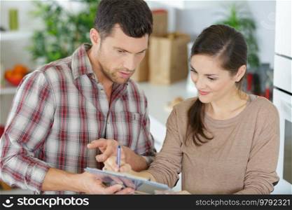 casual couple checking things to do on clipboard