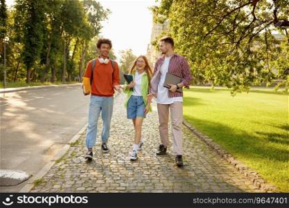 Casual diverse students chatting while walking and hanging out together during university c&us break. Casual diverse students chatting while walking and hanging out together