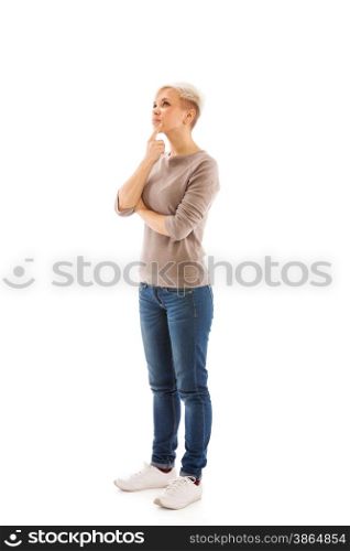 Casual dressed woman is standing and thinking over white isolated background