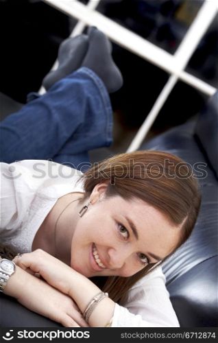 casual girl relaxing at home lying on a sofa