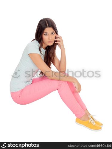 Casual girl sitting on the floor isolated on white background
