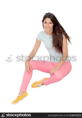 Casual girl sitting on the floor isolated on white background