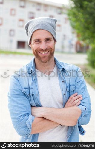 Casual guy with a denim shirt relaxed in the street