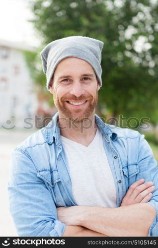 Casual guy with a denim shirt relaxed in the street