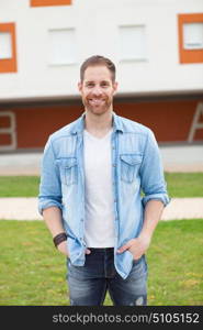 Casual guy with a denim shirt relaxed in the street