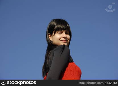 casual latin girl outdoors with the sky in the background