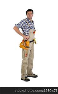 Casual male carpenter stood with hands on hips