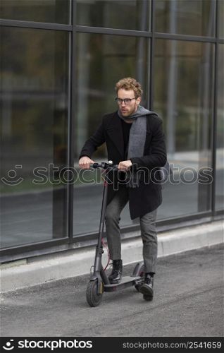 casual male posing with electric scooter 8