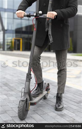 casual male posing with his electric scooter