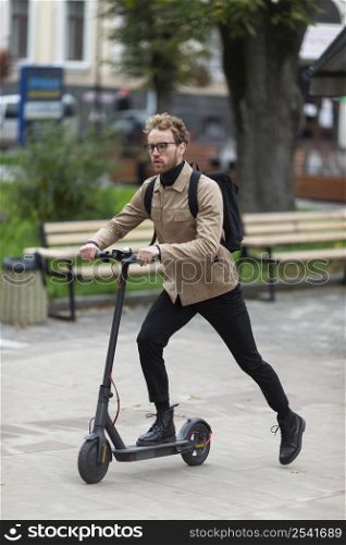 casual male riding electric scooter 4