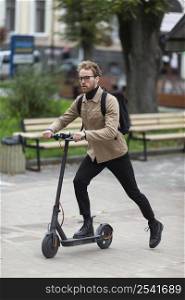 casual male riding electric scooter 4