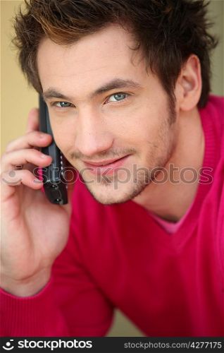 Casual man calling a friend from home