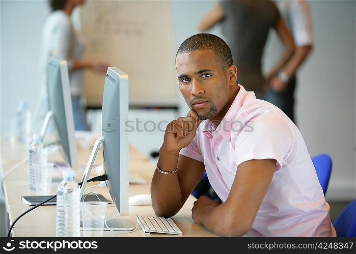 Casual man using a computer in an office