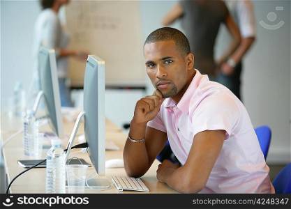 Casual man using a computer in an office