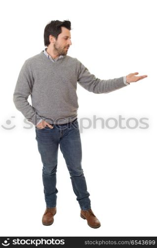 casual man with arm out in a showing gesture, isolated on white. showing gesture