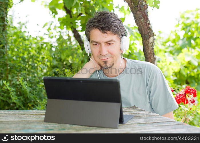 casual man working with a tablet pc, outdoor