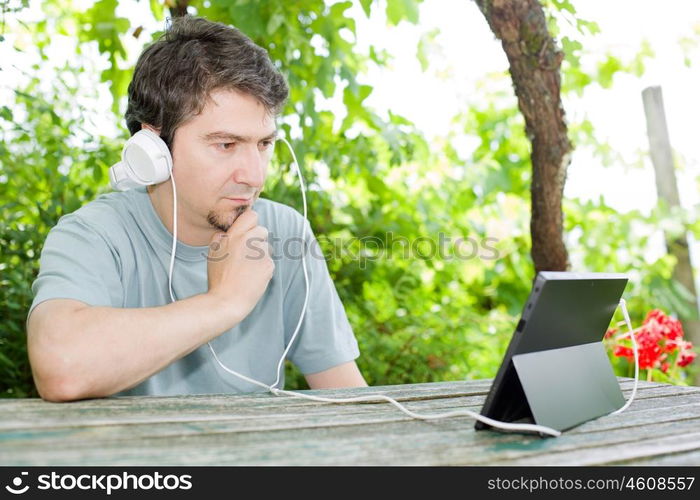 casual man working with a tablet pc, outdoor