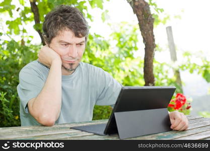 casual man working with a tablet pc, outdoor