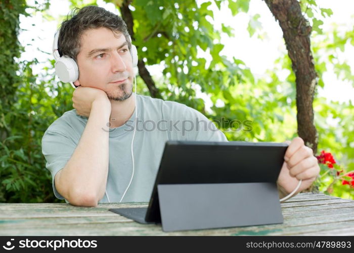 casual man working with a tablet pc, outdoor