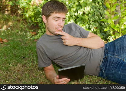 casual man working with a tablet pc, outdoor