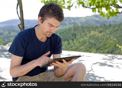 casual man working with a tablet pc, outdoor