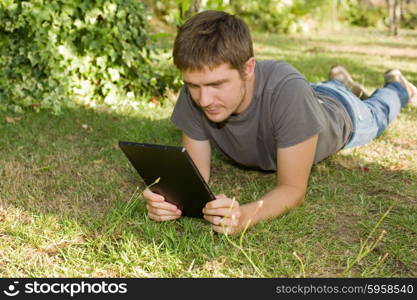 casual man working with a tablet pc, outdoor