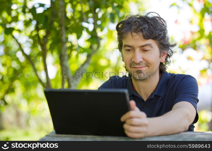 casual man working with a tablet pc, outdoor