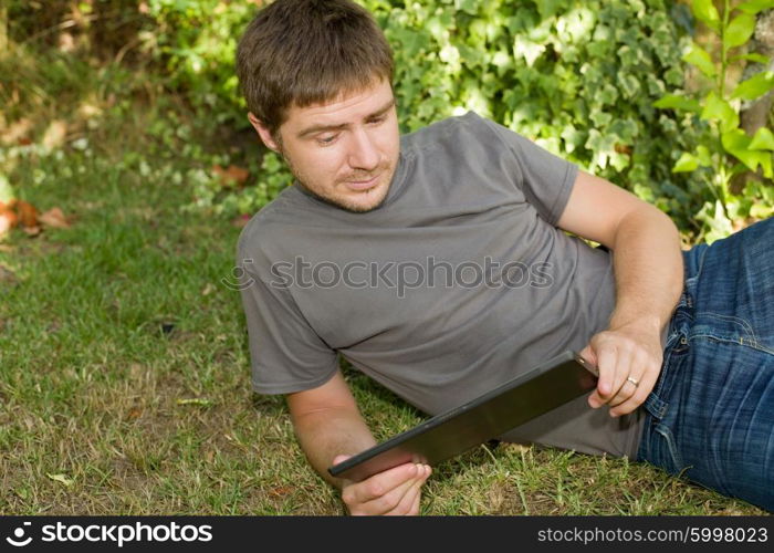 casual man working with a tablet pc, outdoor