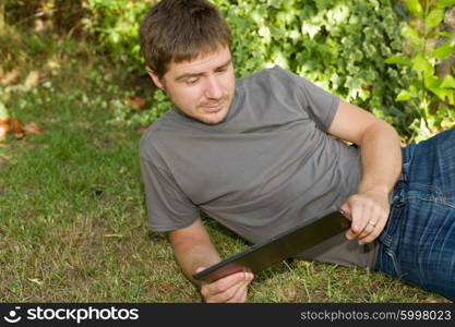 casual man working with a tablet pc, outdoor