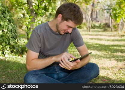 casual man working with a tablet pc, outdoor