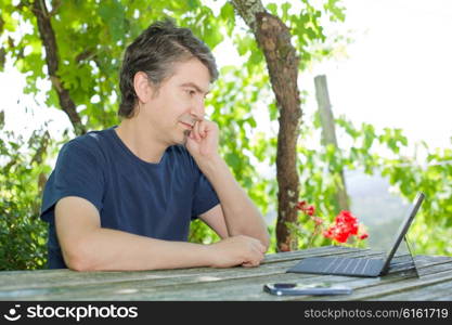 casual man working with a tablet pc, outdoor