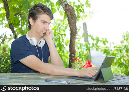 casual man working with a tablet pc, outdoor