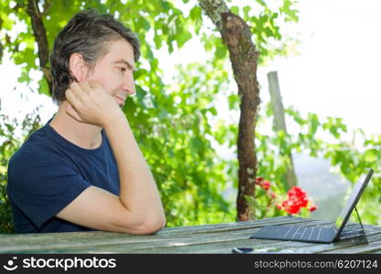 casual man working with a tablet pc, outdoor