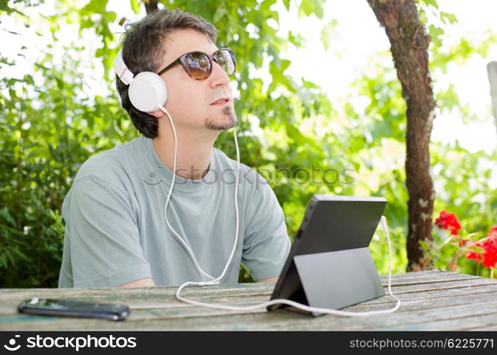 casual man working with a tablet pc, outdoor