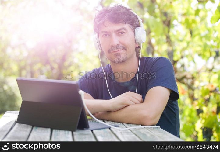 casual man working with a tablet pc, outdoor. working
