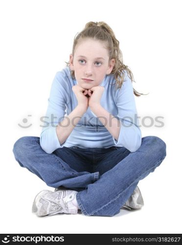 Casual teen crossed legged in shirt and jeans thinking. Over white.