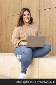 casual teenager holding her laptop 2